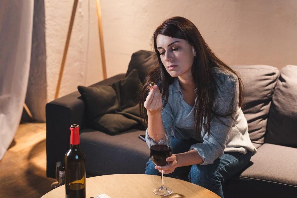 Woman contemplates marriage, divorce, and addiction while drinking wine.